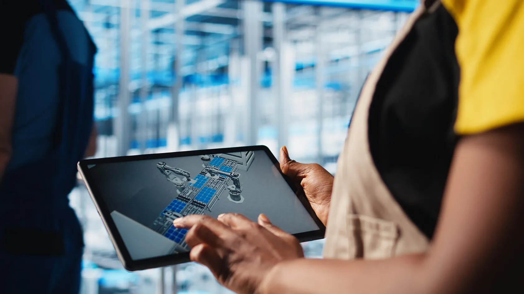 Engineer reviewing a robotic automation system design on a CAD workstation in a warehouse operations center